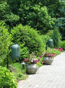Outdoor speakers among garden plants
