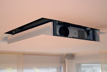 Projector in a retractable enclosure