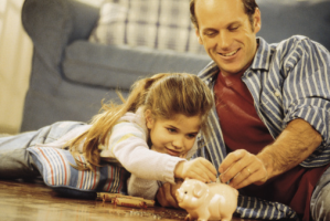 A father and child with a piggy bank